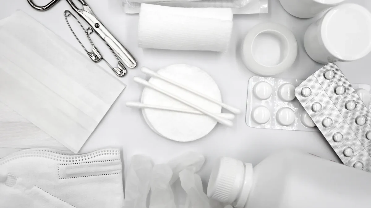 Flat lay of bandages, gauze, gloves and medication