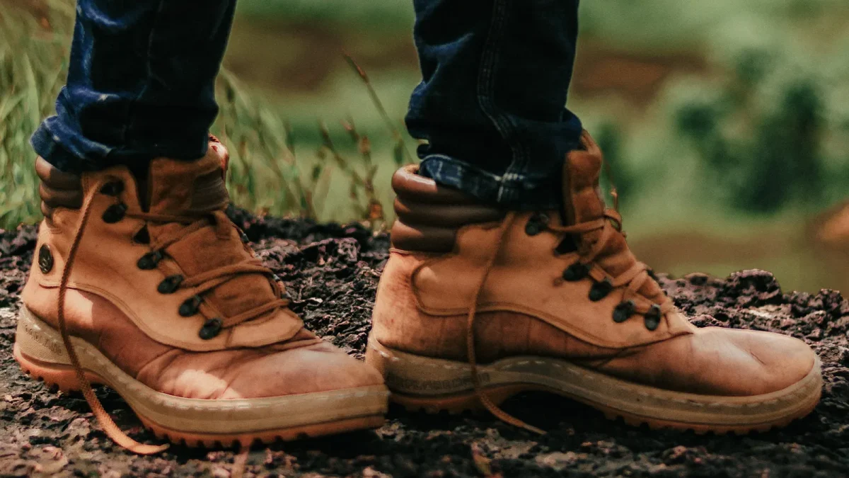 Close-up of brown leather hiking boots on a trail
