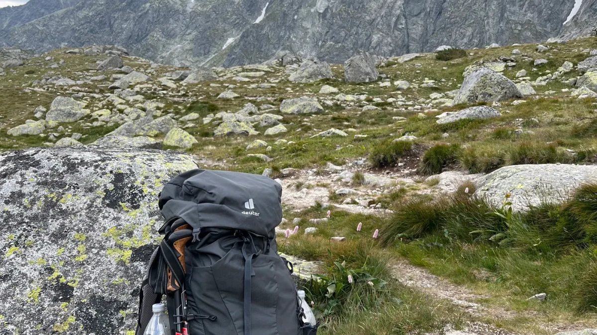 Hiking backpack resting on rocky terrain with the Tatra Mountains behind it